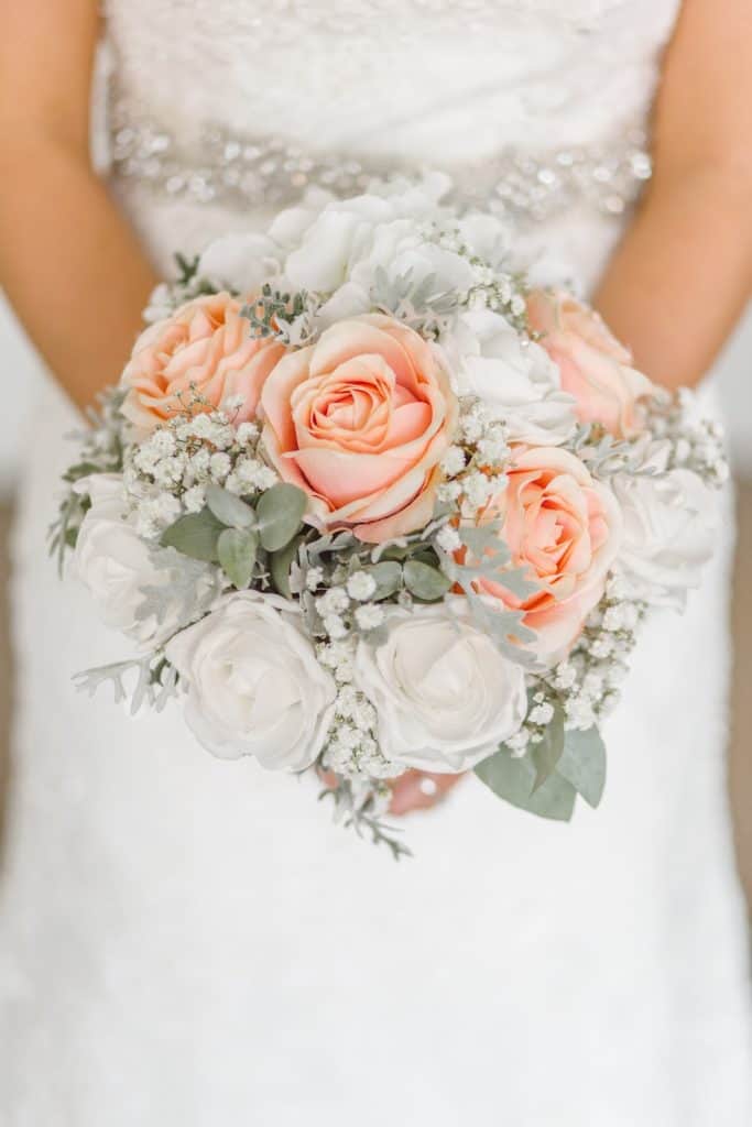 Bride holding bouquet at her waist